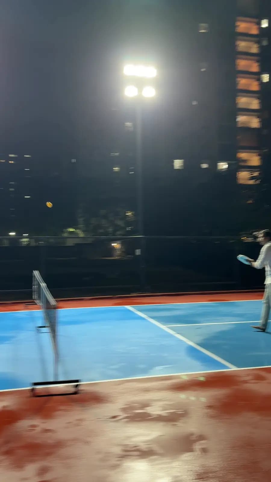 Floodlit pickleball court at night