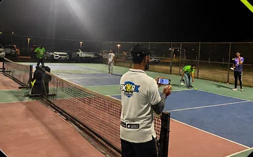 SkorX scorer at the net during a night match