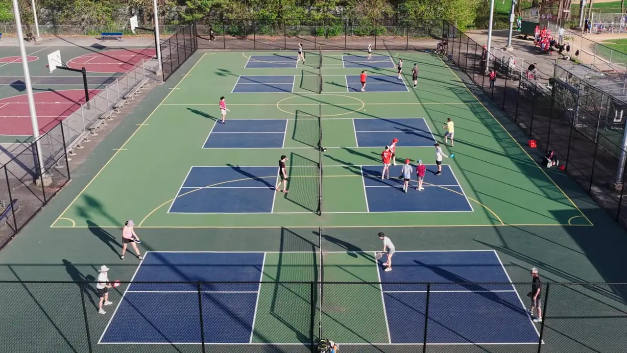 Aerial view of several pickleball courts in use during a tournament
